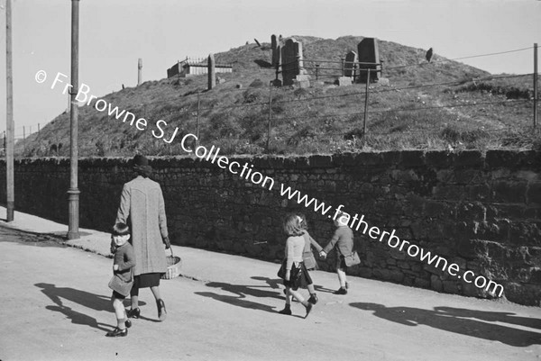 WOMAN BRINGING CHILDREN TO SCHOOL